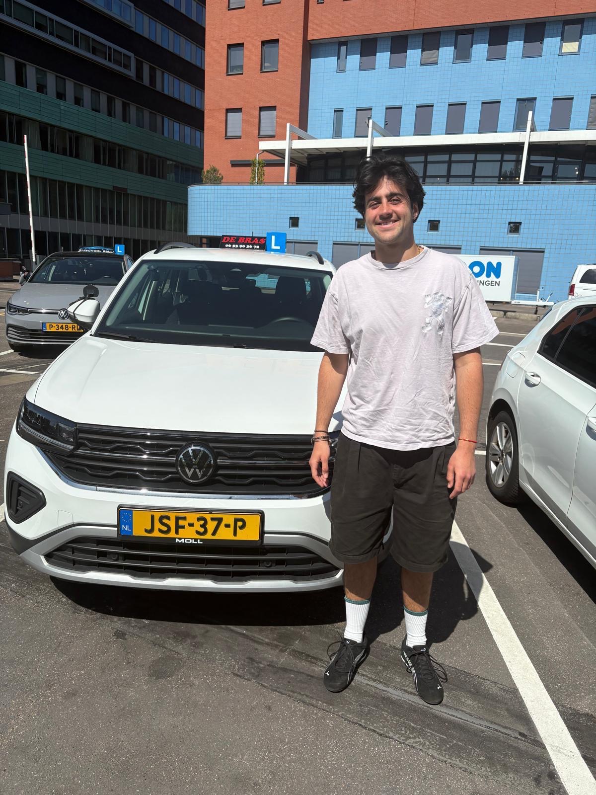 Geslaagde leerling van Rijschool De Bras bij de lesauto